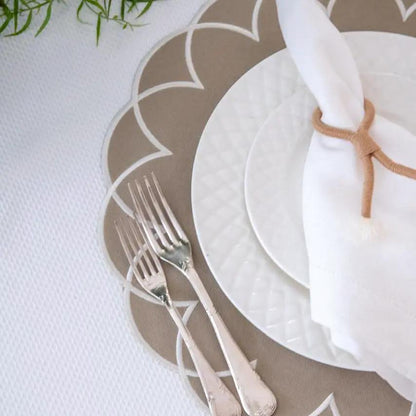 Nautical knot napkin ring in tan rope around white napkin atop beige coastal charger plate on Tampa Home & Garden Store
