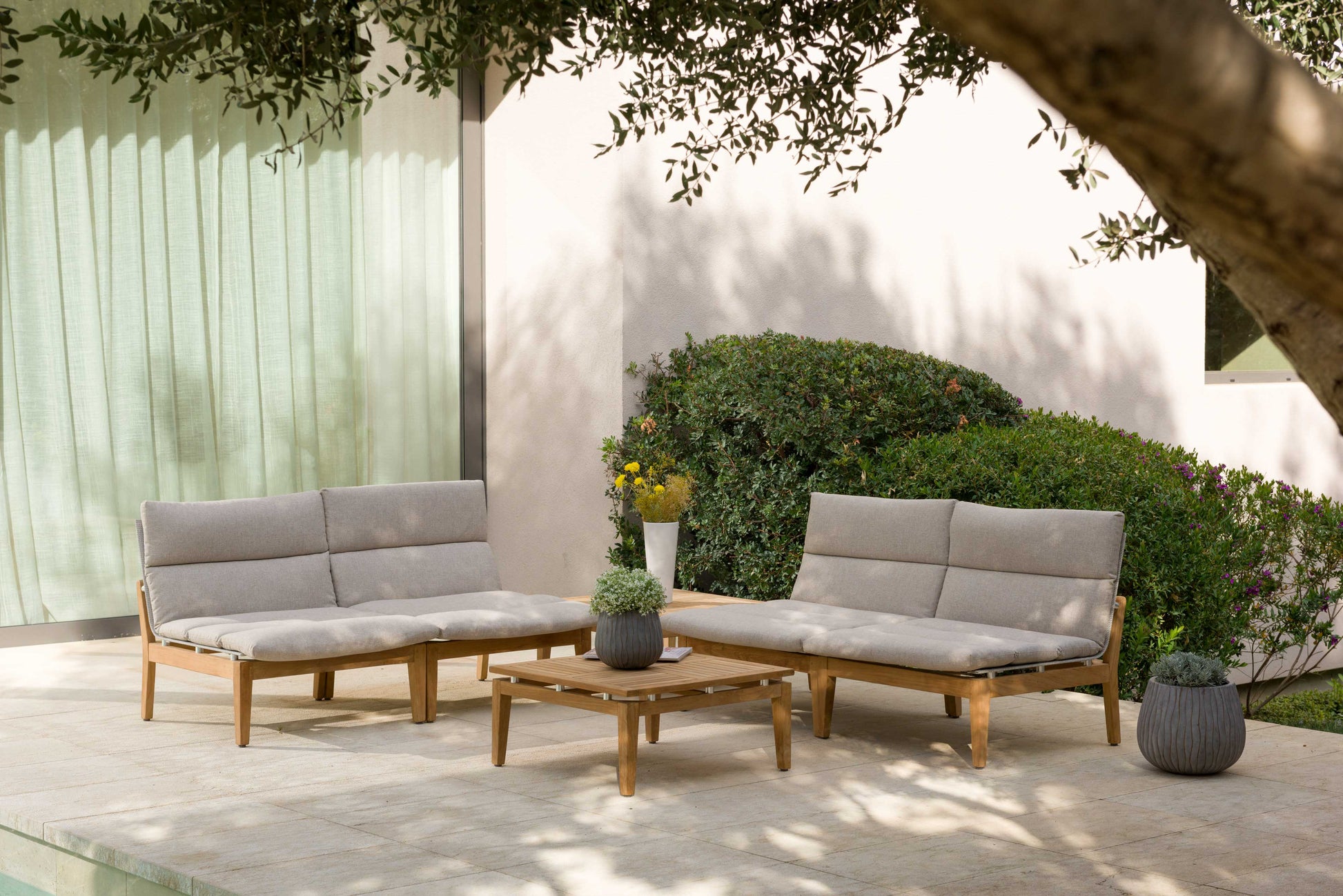 Arno 6pc Corner Set Light outdoor with light gray cushions and wooden frames on a patio on Tampa Home & Garden Store