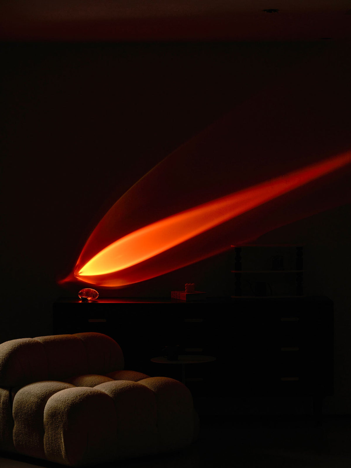 Seren crystal glass table lamp with chrome base casts warm orange glow across a dark room on Tampa Home & Garden Store