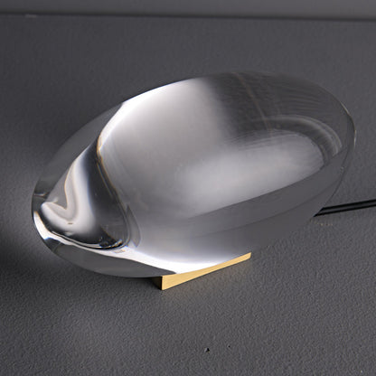 Seren crystal glass table lamp with curved teardrop silhouette resting on a wooden base on Tampa Home & Garden Store
