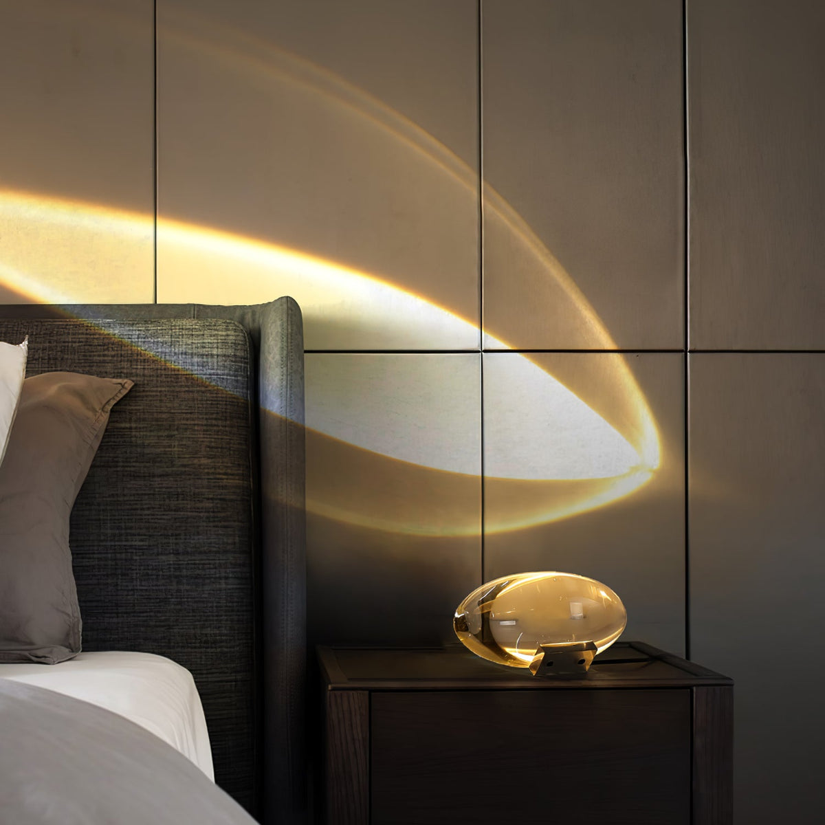 Seren crystal glass table lamp with chrome base on dark nightstand casting glow on wall on Tampa Home & Garden Store