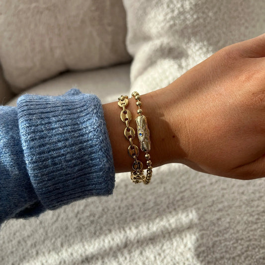 Evil Eye Barrel Closure Bracelet gold-tone with disc links on wrist blue knit sleeve on Tampa Home & Garden Store