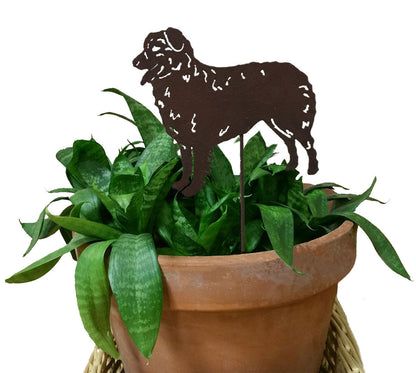Rust-colored Australian Shepard plant stake silhouette in a pot with green foliage on Tampa Home & Garden Store