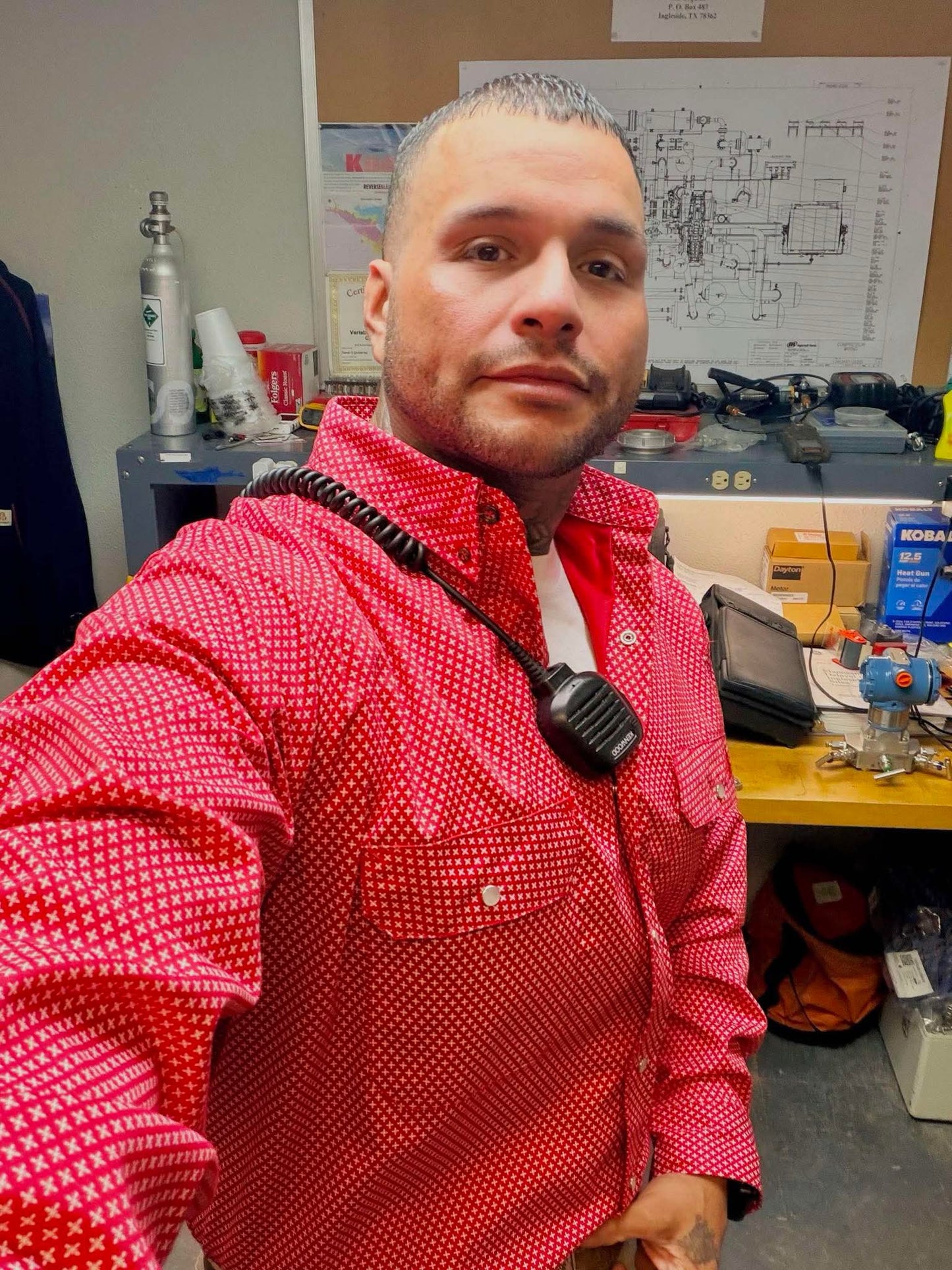 Static FR Pearl Snap Work shirt Alpha Red with U.S. flag pattern, red work safety shirt worn by a man in a workshop on Tampa Home & Garden Store