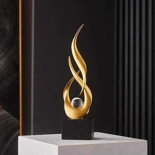 Resin Water Rising Sculpture for Home Decor in gold with a clear orb on a black base on Tampa Home & Garden Store