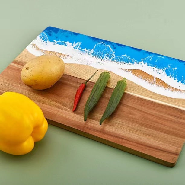 Wood and resin cutting board with blue ocean epoxy edge; natural grain peppers and two okra on Tampa Home & Garden Store