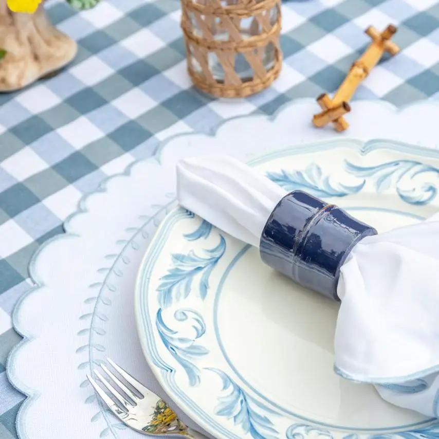 Brazilian Bamboo Napkin Ring by Talah Home in blue glaze around a white napkin on blue plate on Tampa Home & Garden Store