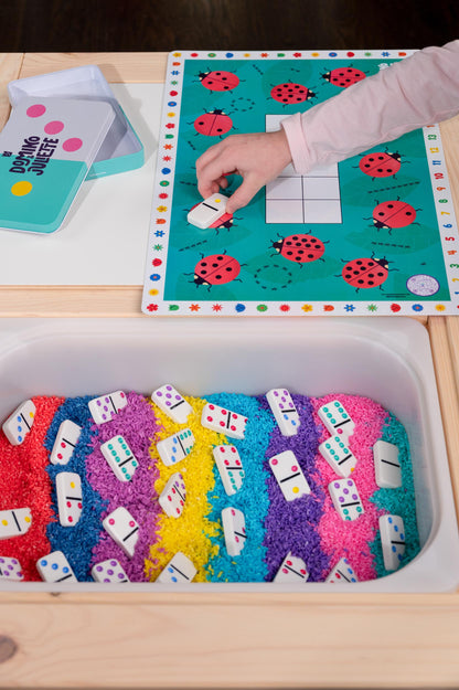 Bright Play Dominos by Domino & Juliette on teal ladybug game board with white domino tiles on Tampa Home & Garden Store