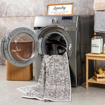 Pearl Holi-4601 washable area rug, Boutique Rugs, ivory gray pattern, draped over a washer on Tampa Home & Garden Store