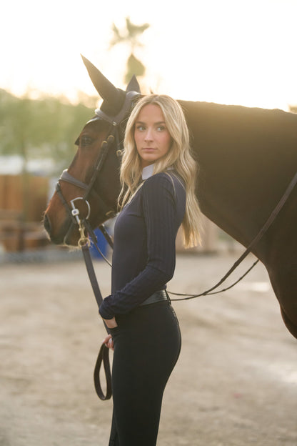 LOLLY Show Shirt navy by BellEq Equestrian Apparel, riding top worn beside horse at sunset on Tampa Home & Garden Store