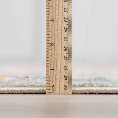 Bolinas area rug, soft beige tufted pile with subtle flecks, shown beside a measuring ruler on Tampa Home & Garden Store