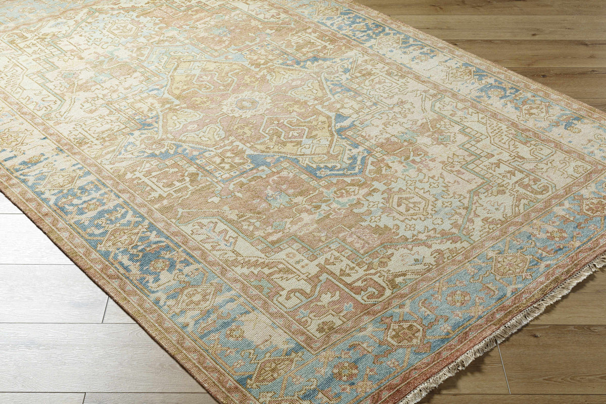 Bangonay Area Rug by Boutique Rugs in soft beige with blue and peach accents fringed edges on Tampa Home & Garden Store