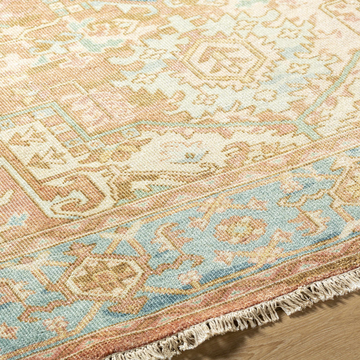 Bangonay Area Rug by Boutique Rugs in soft peach, cream, and blue with fringe clearance on Tampa Home & Garden Store