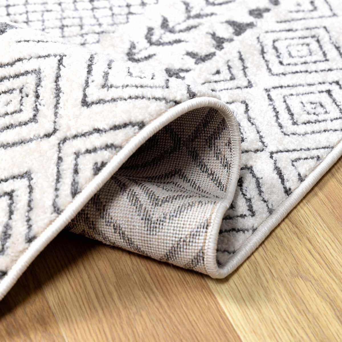 Burdette Soft Neutral Rug with cream field and gray geometric border on Tampa Home & Garden Store