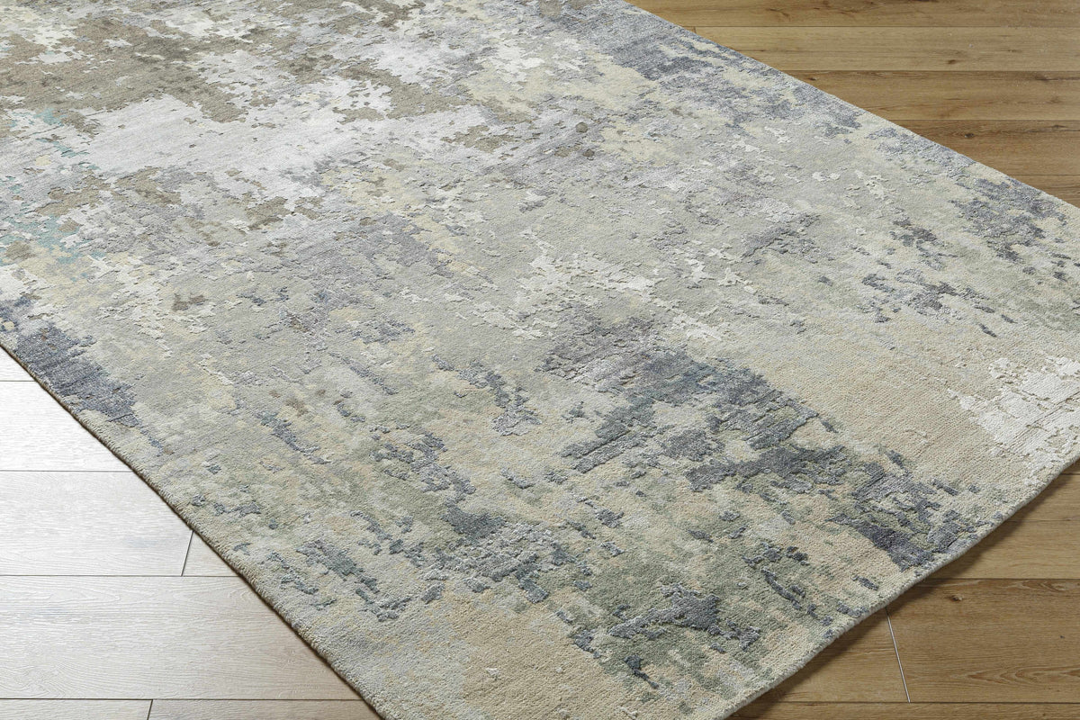 Bued Handmade Wool-Blend Rug with gray cream blue abstract pattern on wood floor on Tampa Home & Garden Store