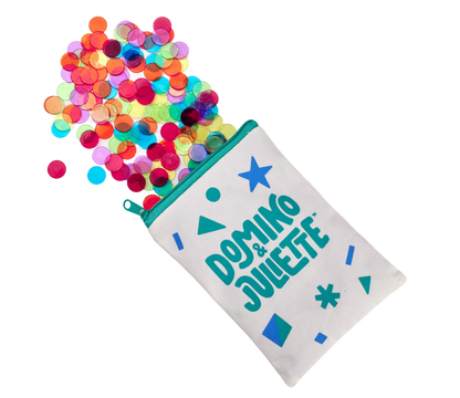 Counting chips in assorted translucent colors spilling from a teal zip pouch, Domino & Juliette on Tampa Home & Garden Store