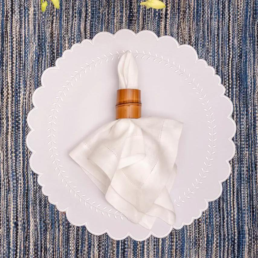 Brazilian Bamboo Napkin Ring by Talah Home on white napkin atop a scalloped plate on Tampa Home & Garden Store