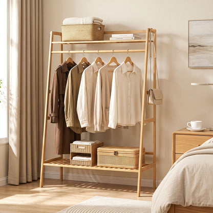 Bamboo garment rack with shelves and hanging rod; beige shirts on hangers with baskets and a bag on Tampa Home & Garden Store