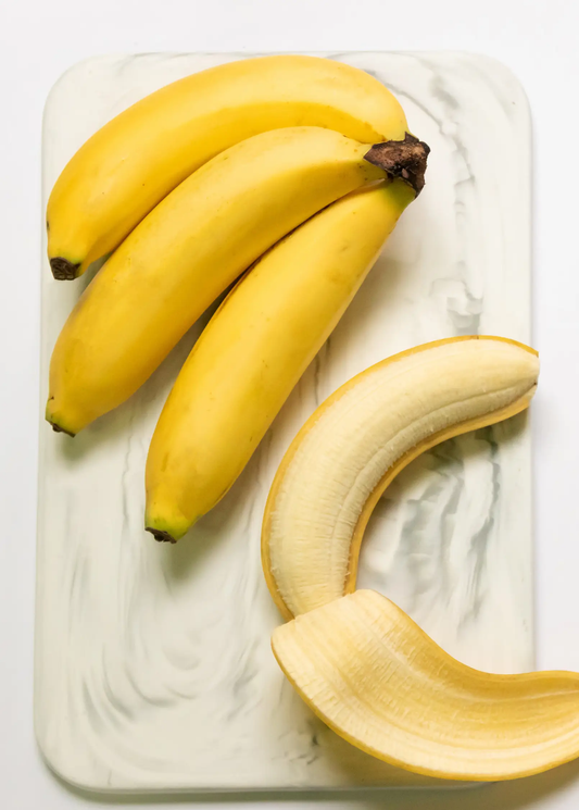 Banana Dwarf Cavendish fruit bunch from Sow Exotic; three yellow bananas on a white tray on Tampa Home & Garden Store