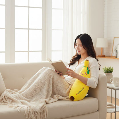 Smiley Banana stuffed animal by Shaketea, bright yellow banana plush with a cute face on a sofa on Tampa Home & Garden Store