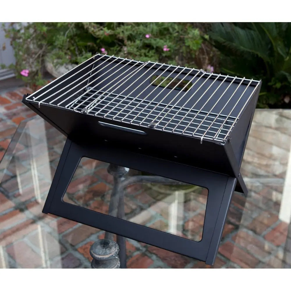 Black charcoal grill on a metal stand with chrome cooking grate on Tampa Home & Garden Store