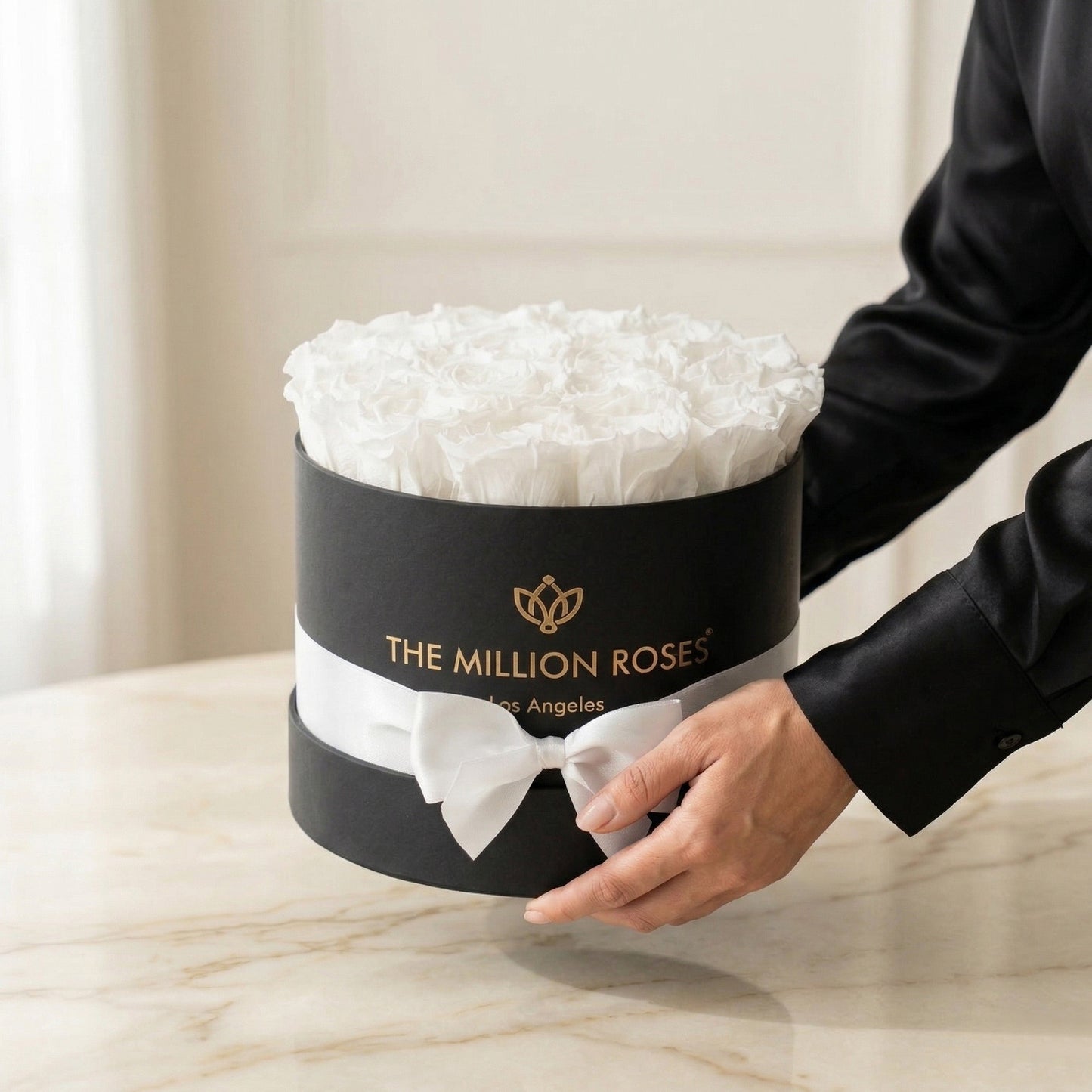 Classic Black Box with White Roses, black cylindrical gift box with gold The Million Roses logo on Tampa Home & Garden Store