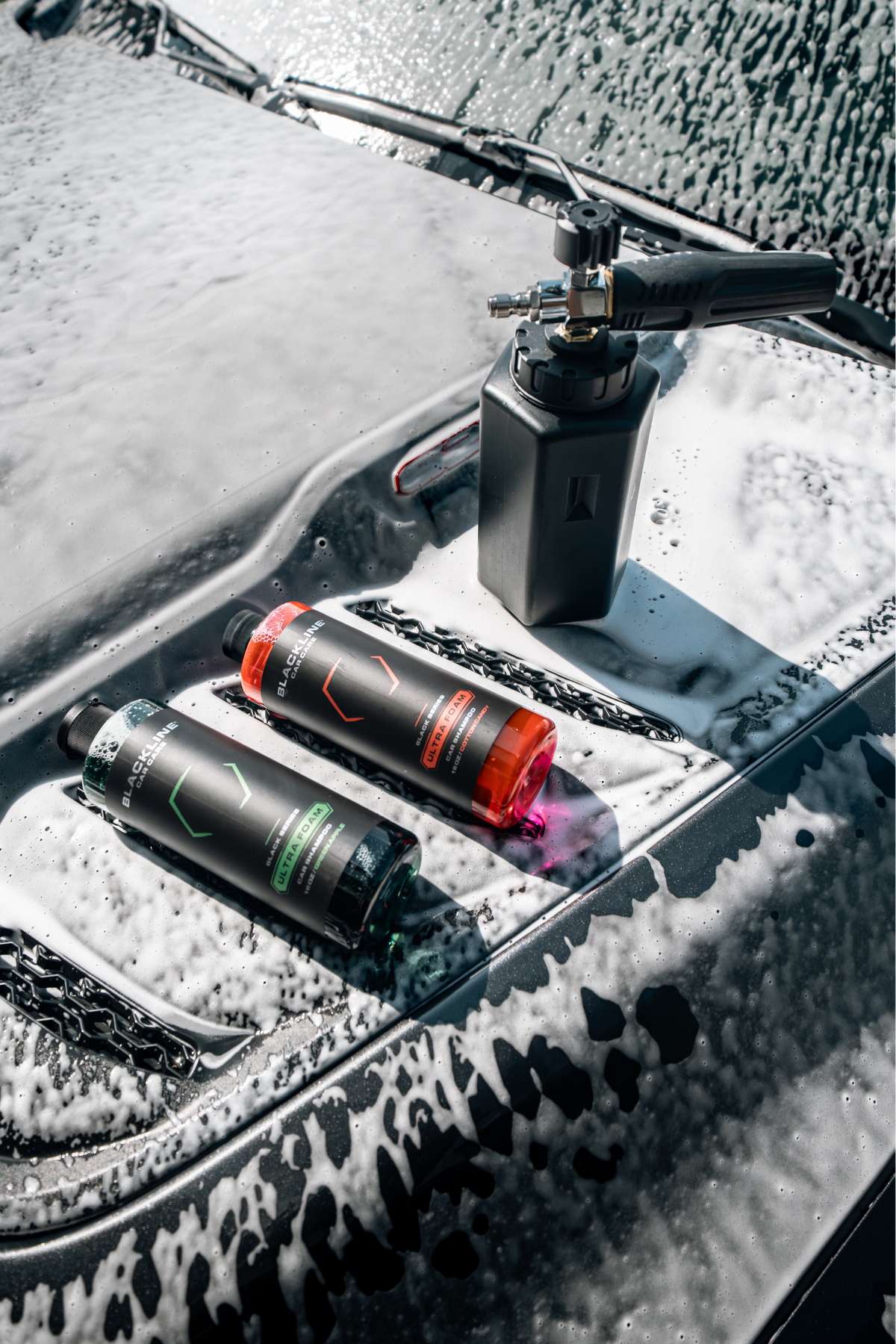 Blackline Car Care ULTRA FOAM car shampoo bottles with a foam cannon on a soapy car hood on Tampa Home & Garden Store
