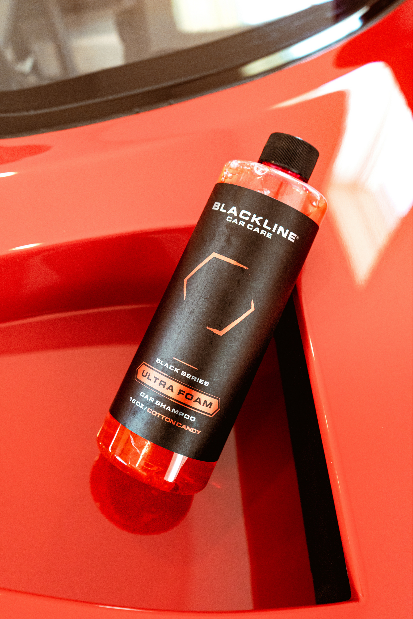 Blackline Car Care Ultra Foam shampoo bottle with black label beside red car on Tampa Home & Garden Store
