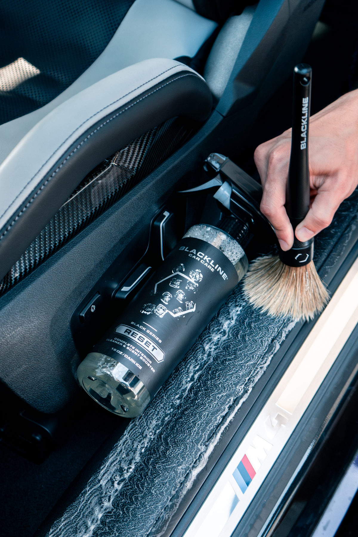 Blackline Reset Interior Cleaner bottle with Blackline brush in a car door pocket on Tampa Home & Garden Store