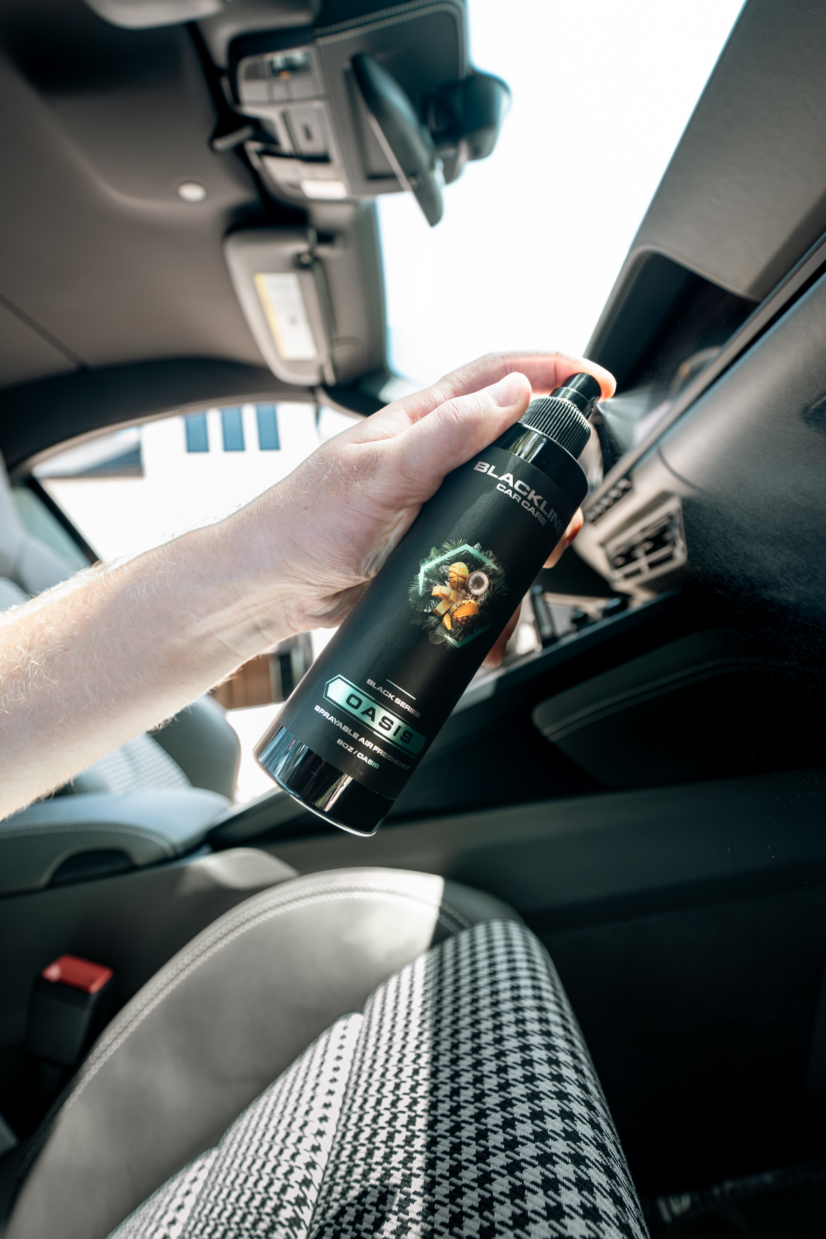 Blackline Car Care 8oz car air freshener spray held in a hand inside a vehicle on Tampa Home & Garden Store