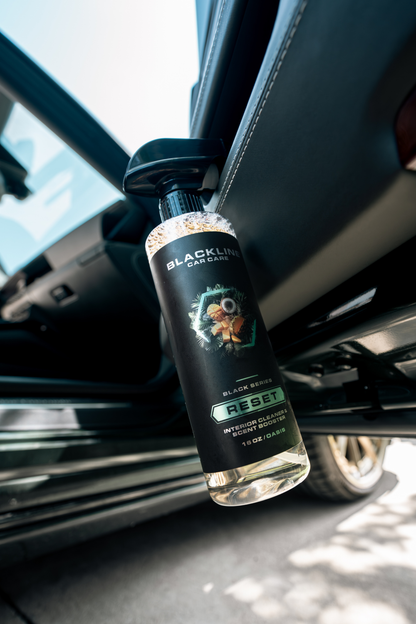 Blackline Car Care RESET interior cleaner scent booster bottle in black mounted in car on Tampa Home & Garden Store