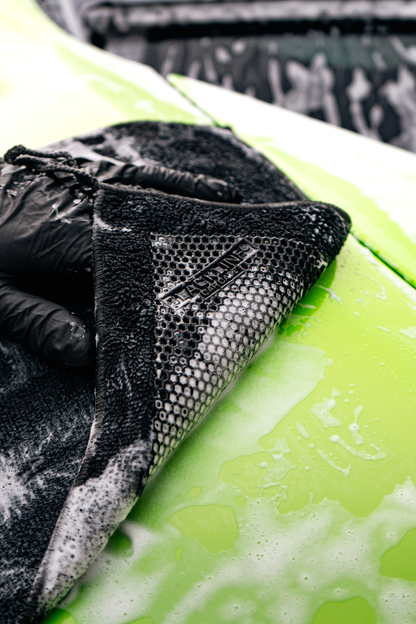 Blackline synthetic clay towel with a black plush pad and hex mesh on a lime green car on Tampa Home & Garden Store