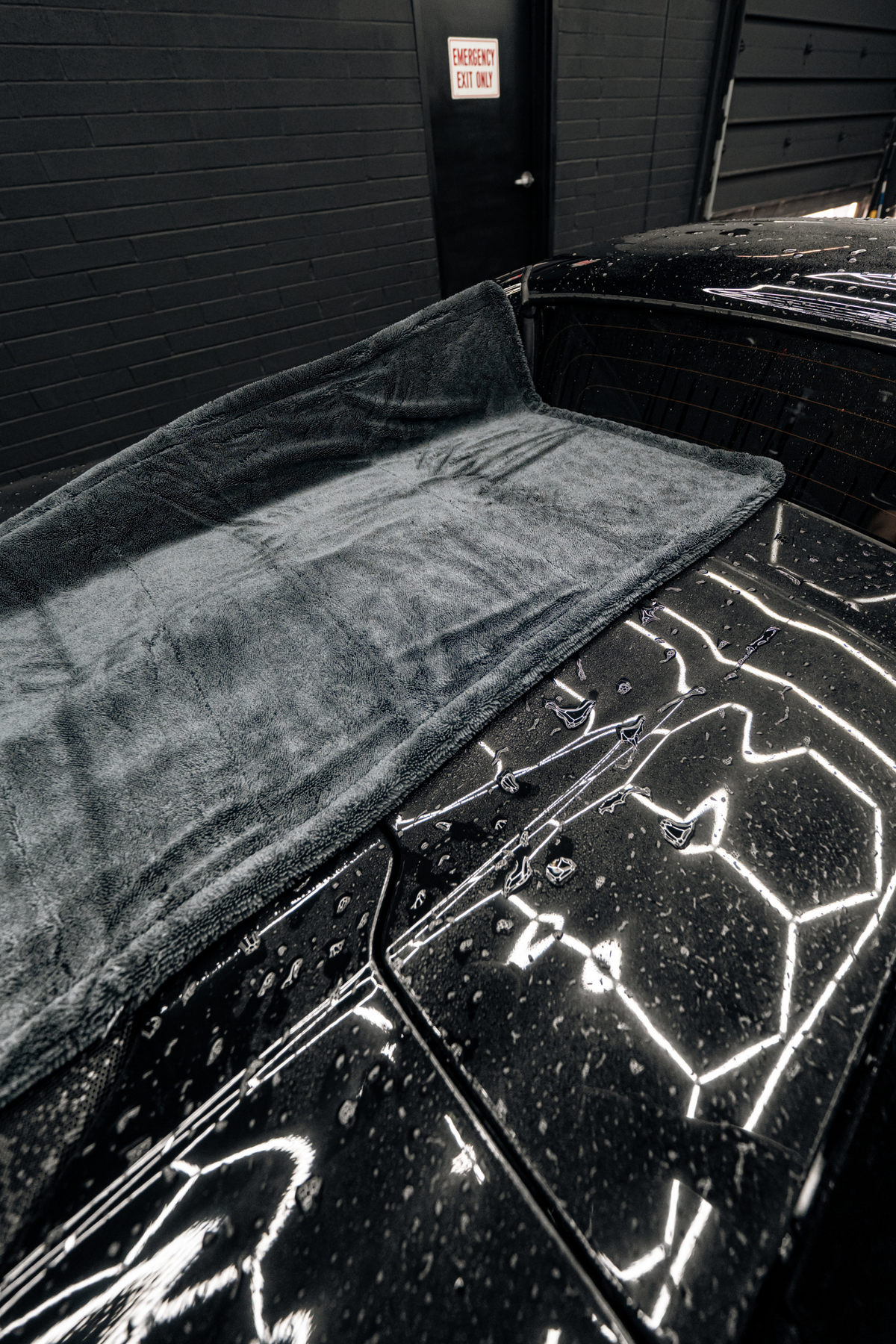 BLACKLINE Twisted-Loop Drying Towel gray plush microfiber on a black car on Tampa Home & Garden Store