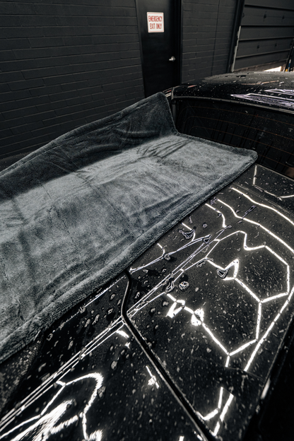 BLACKLINE Twisted-Loop Drying Towel gray plush microfiber on a black car on Tampa Home & Garden Store