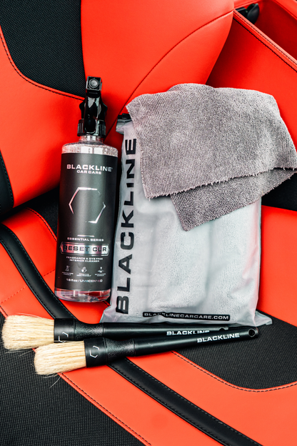 Blackline Car Care RESET interior cleaner spray bottle with gray towel on red car seat on Tampa Home & Garden Store