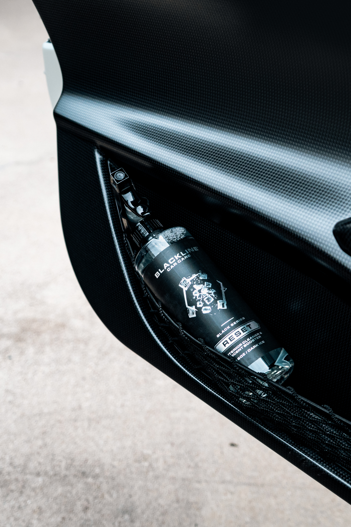 BLACKLINE RESET interior cleaner bottle in carbon fiber car door pocket on Tampa Home & Garden Store