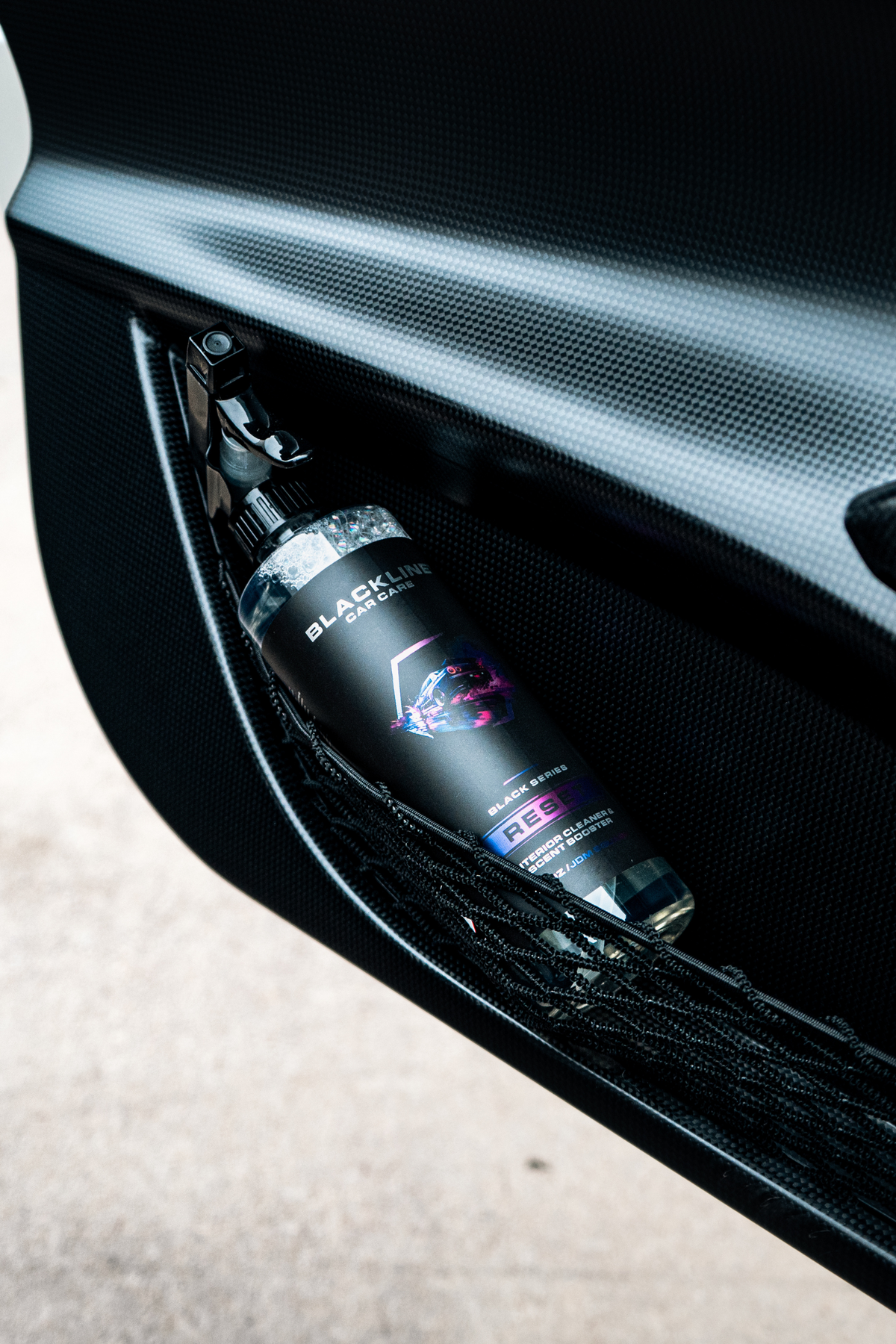 Blackline Car Care Reset Interior Cleaner & Scent Booster spray bottle in a car door pocket on Tampa Home & Garden Store