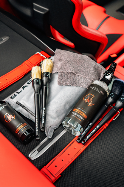 BLACKLINE Reset Interior Cleaner & Scent Booster bottle with brushes in red and black car on Tampa Home & Garden Store