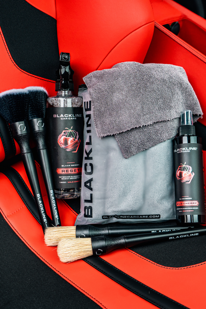 Blackline Reset Interior Cleaner & Scent Booster spray bottle with gray towel on red car seat on Tampa Home & Garden Store