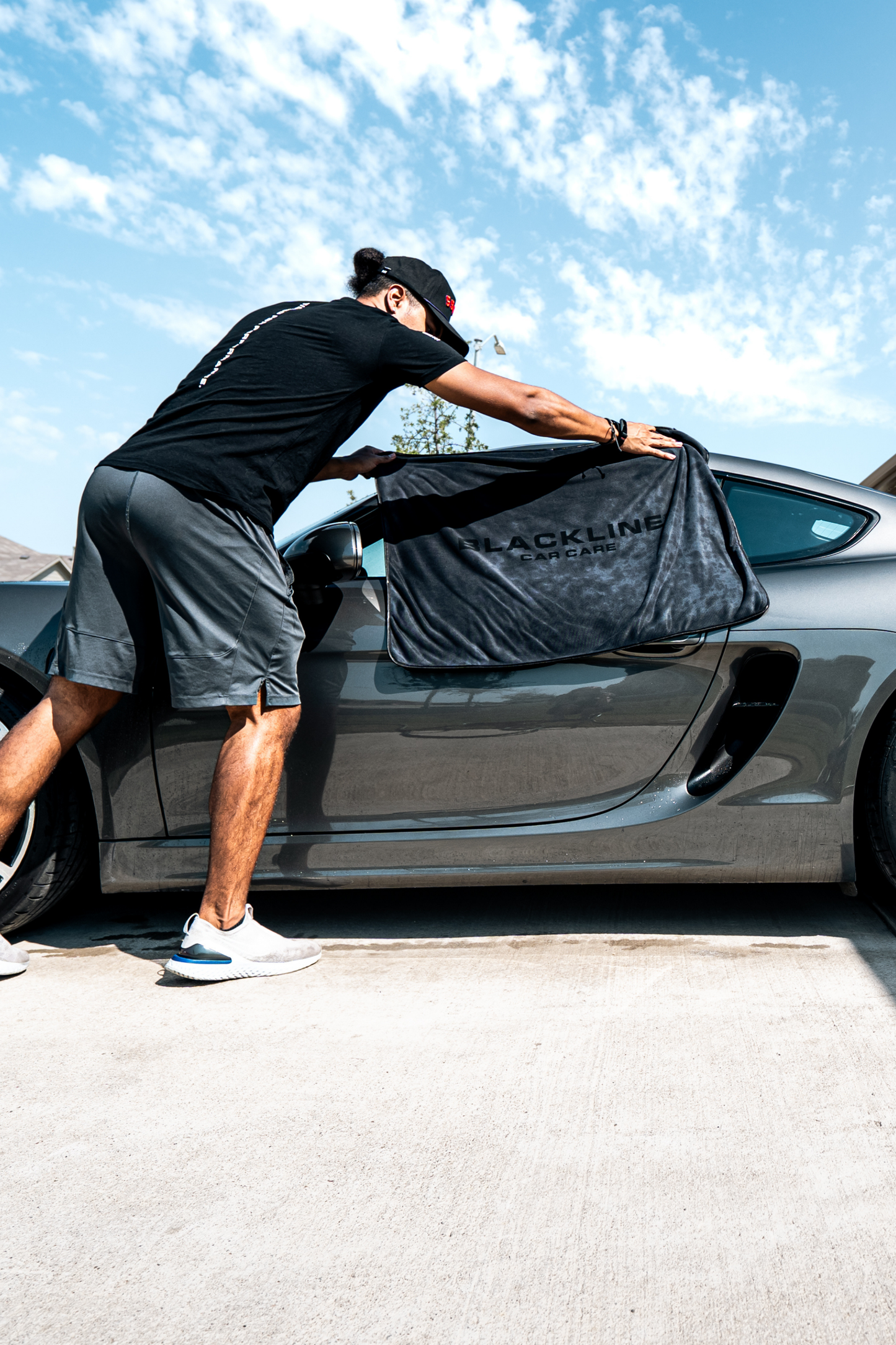 Foam Cannon Pro logo on Blackline Car Care cover placed over a gray car outdoors on Tampa Home & Garden Store
