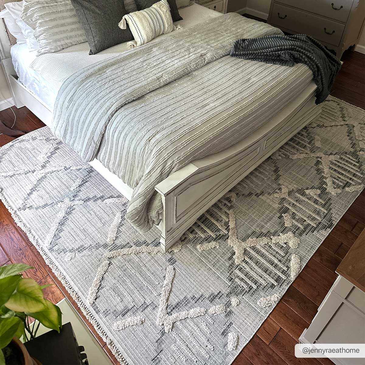 Bogtong High-Low Rustic Rug in light gray and cream with geometric pattern under bedding on Tampa Home & Garden Store