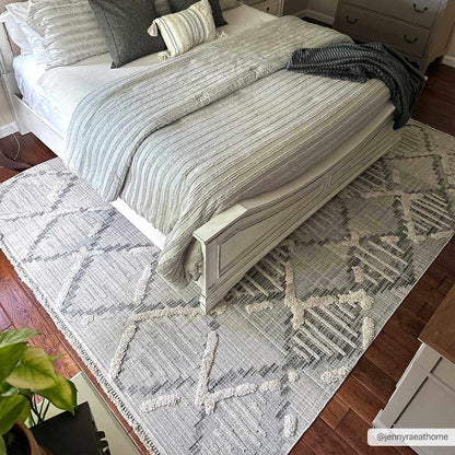 Bogtong High-Low Rustic Rug in light gray and cream with geometric pattern under bedding on Tampa Home & Garden Store