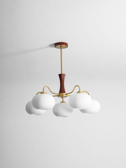 Persimmon glass chandelier with brass arms and wood accent mount, six white glass globes on Tampa Home & Garden Store