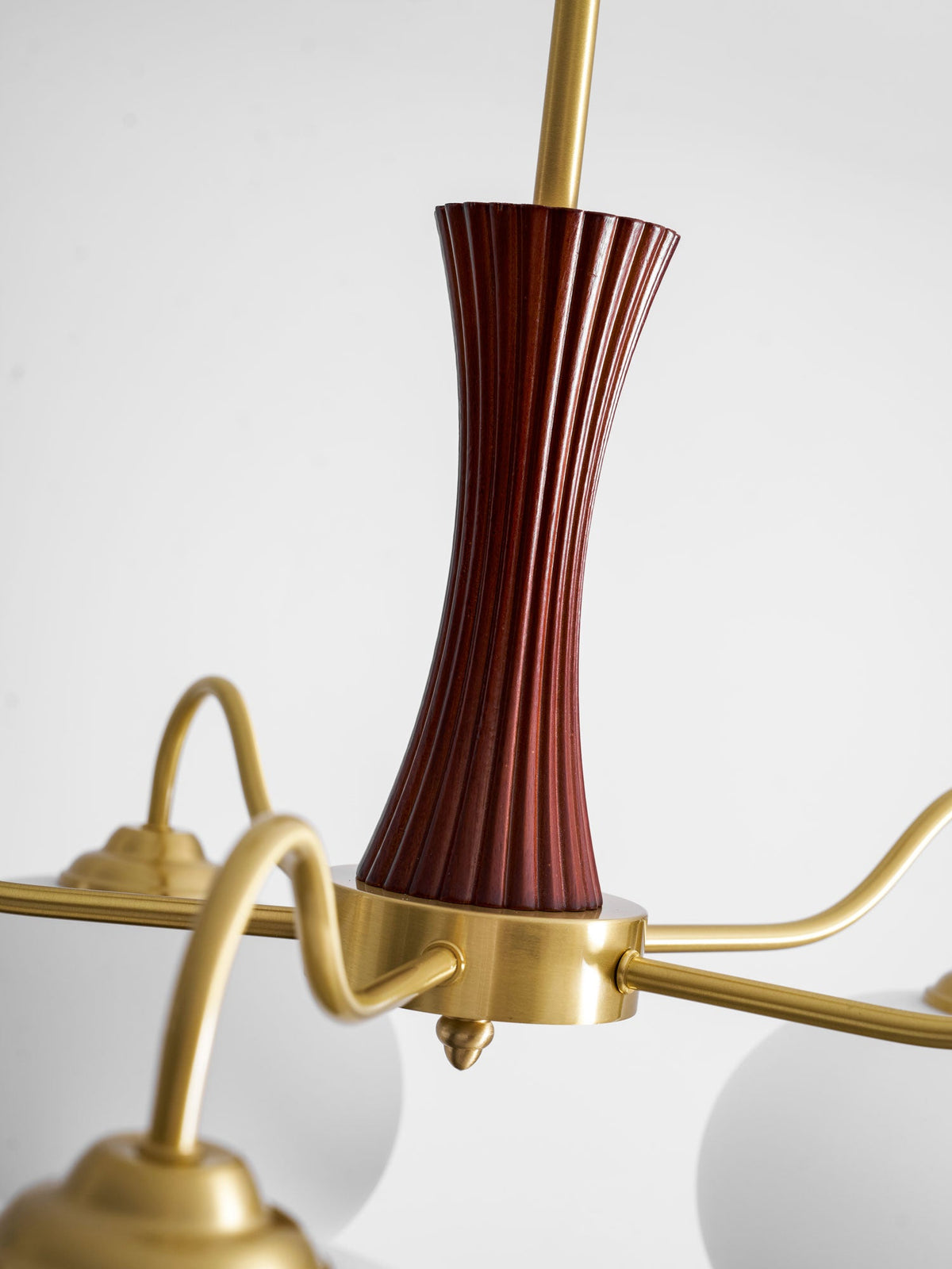Persimmon glass chandelier with brass arms; wood-accent column and white shades Moktan Sabai on Tampa Home & Garden Store