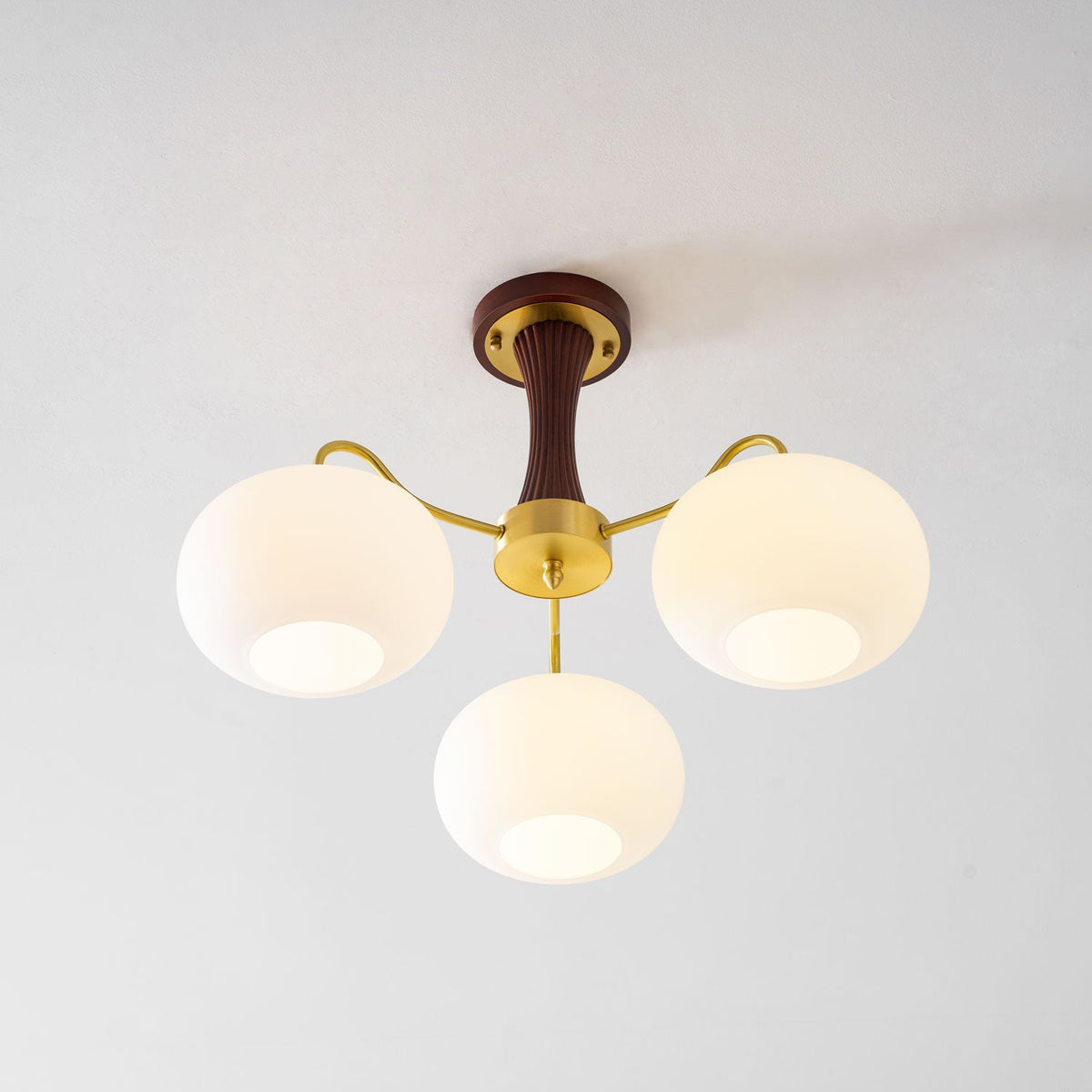 Persimmon glass chandelier with brass arms and wood-accent canopy, four globes on Tampa Home & Garden Store