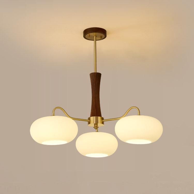Persimmon glass chandelier with brass arms and wood center, three-globe pendant light on Tampa Home & Garden Store