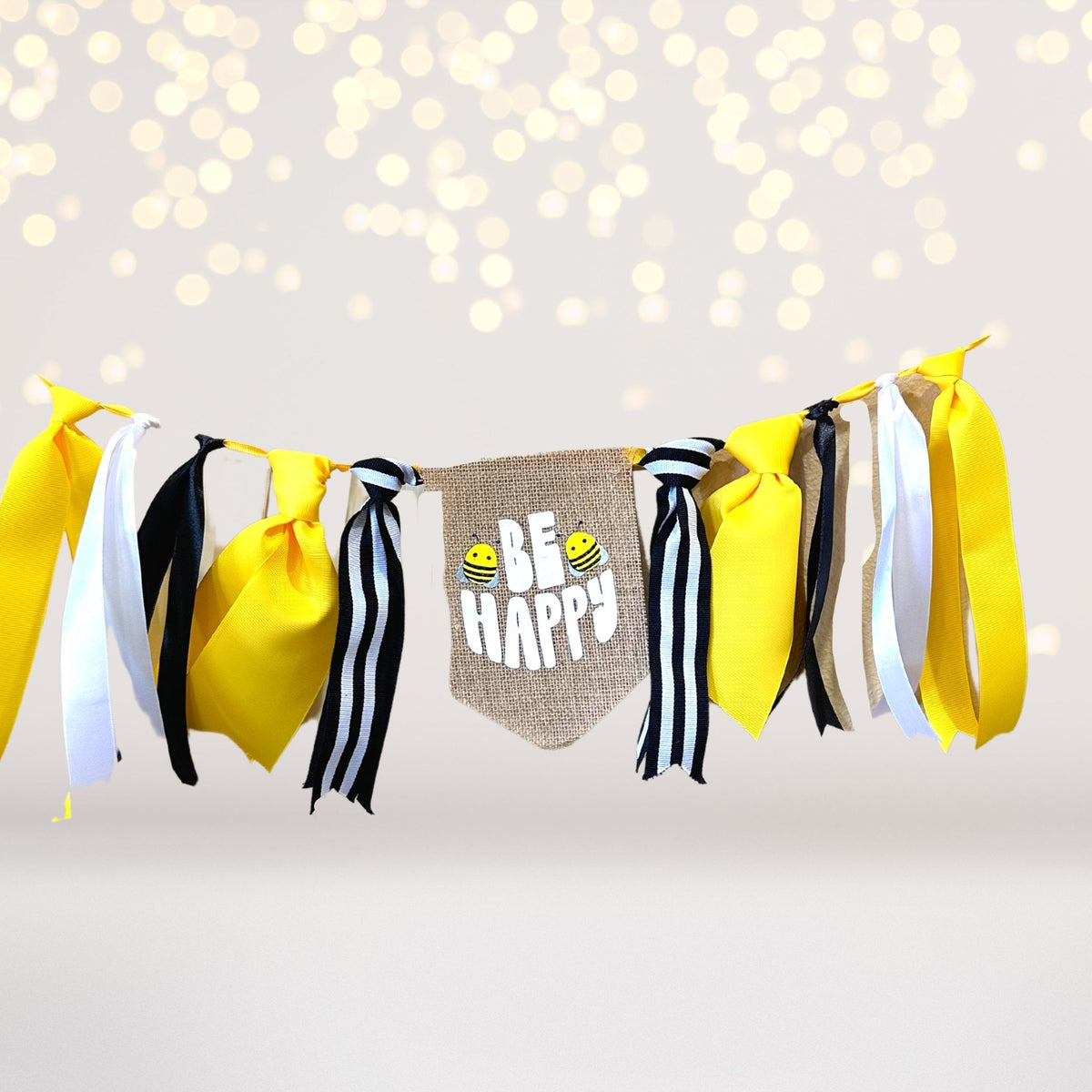 Play set banner garland with yellow, white and black ribbons and a burlap Bee Happy tag; bees on Tampa Home & Garden Store