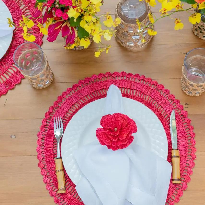Buriti straw placemats red crochet-edge with white napkin and flower on wood table on Tampa Home & Garden Store