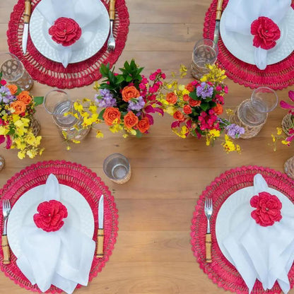 4 Buriti straw placemats by Talah Home; red round woven mats with white napkins and red flowers on Tampa Home & Garden Store