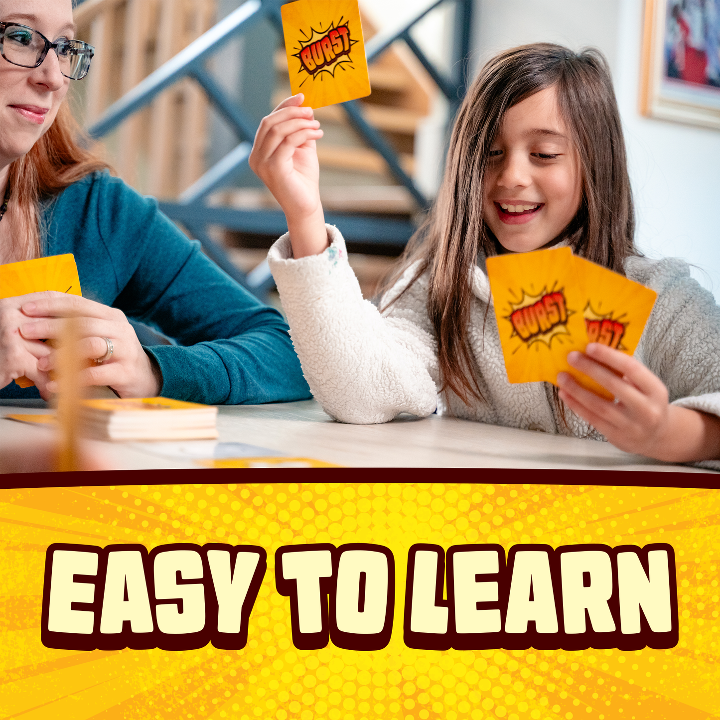 Burst card game by Lost Boy Entertainment, two players hold orange Burst cards and smile on Tampa Home & Garden Store